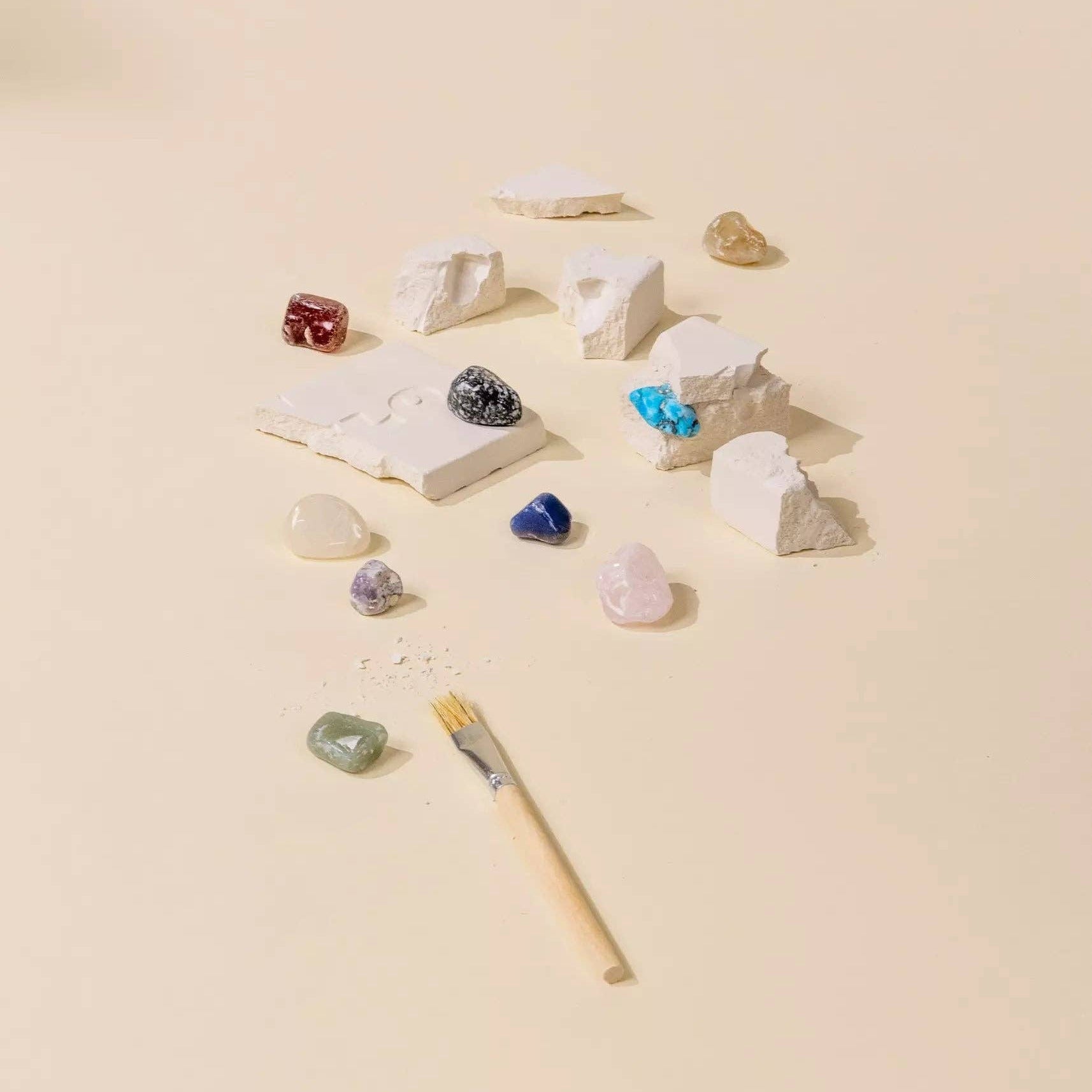 Collection of small stones and a brush on a beige background