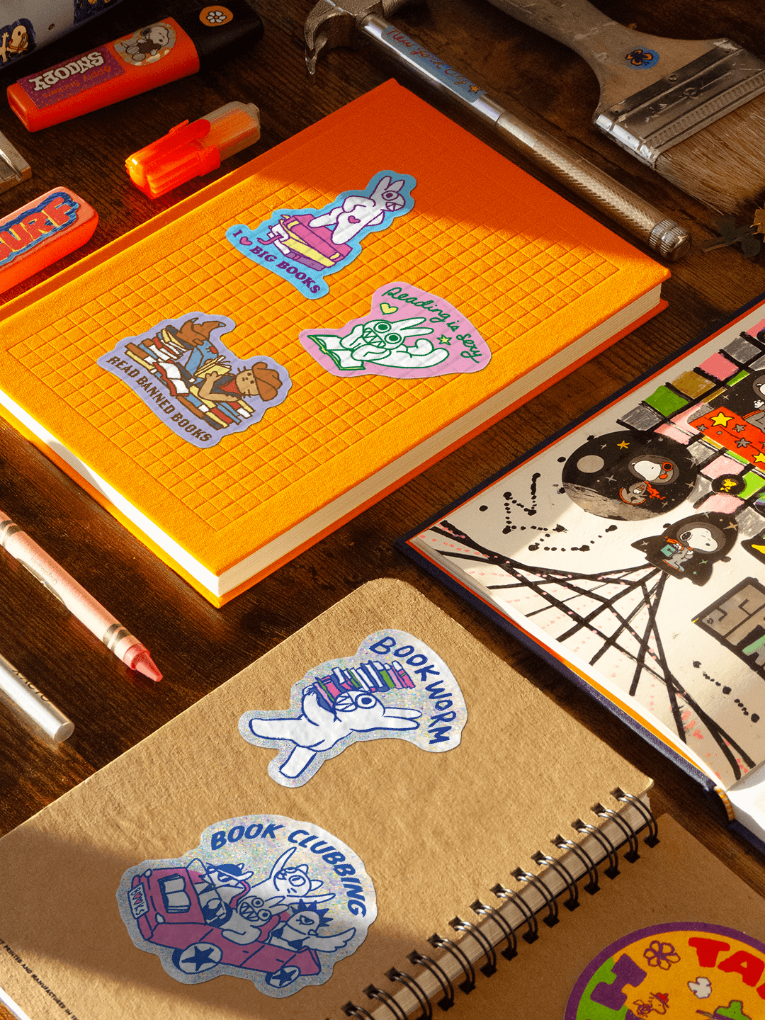 Notebooks with stickers on a desk with stationery items