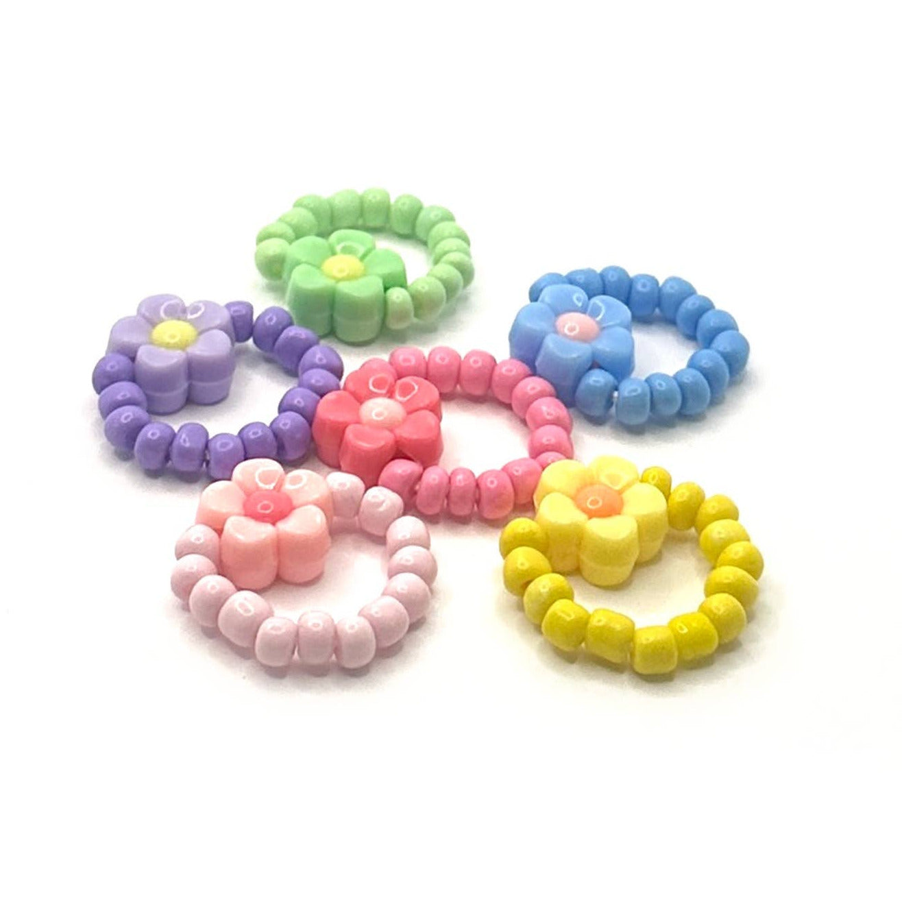 Set of colorful beaded hair ties on a white background