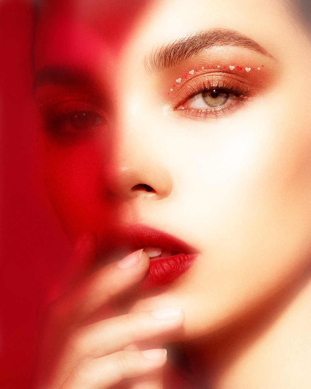 Close-up of a person with red lipstick and a blurred background