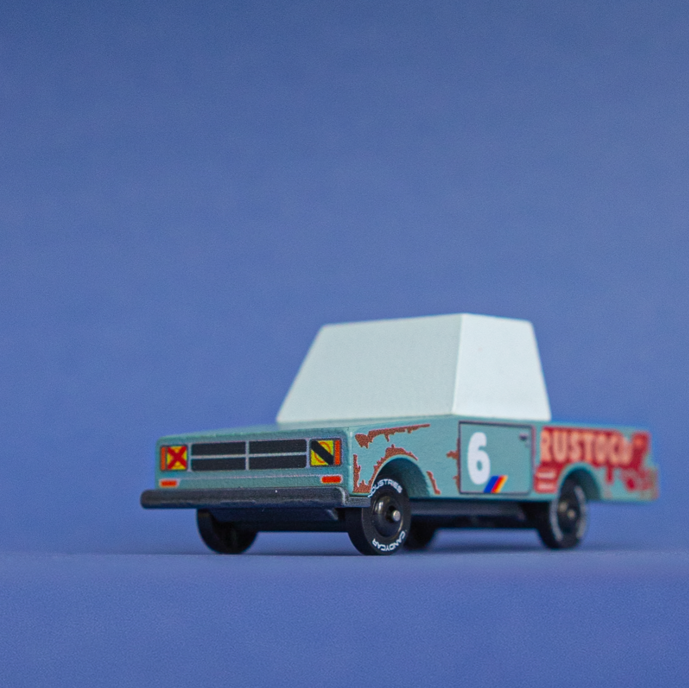 Model truck with 'Rustler' branding on a blue background
