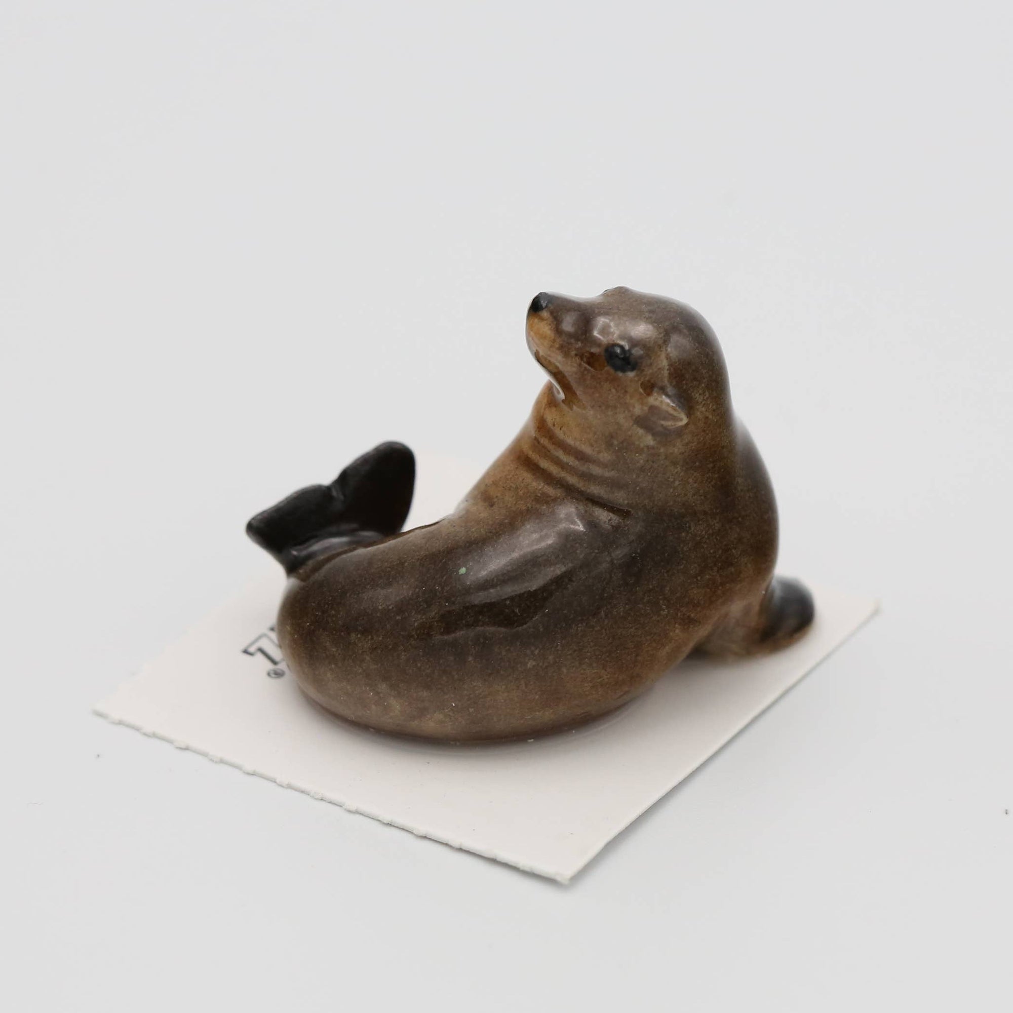 ceramic sculpture of a seal on a white background