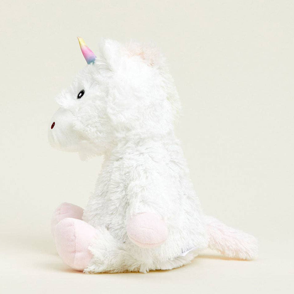 Plush unicorn toy on a light beige background