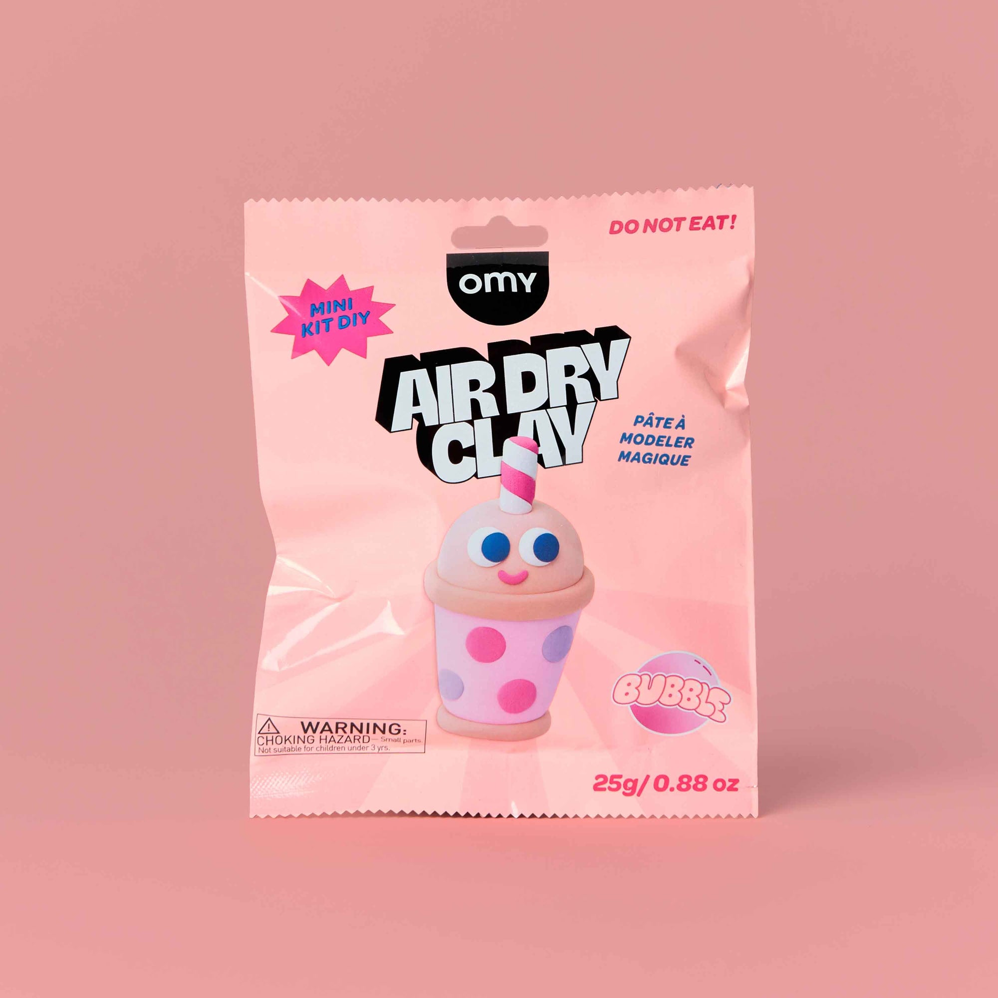 Packaging of OMY air dry clay with a pink background