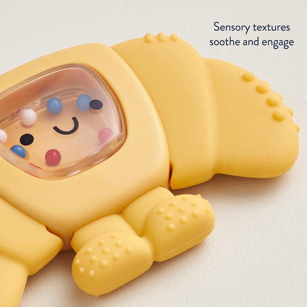 Yellow soft toy with colorful beads inside, on a light background