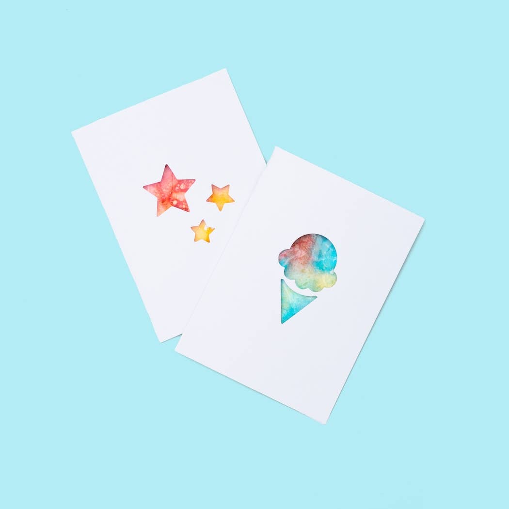 Two watercolor cards with star and ice cream designs on a light blue background