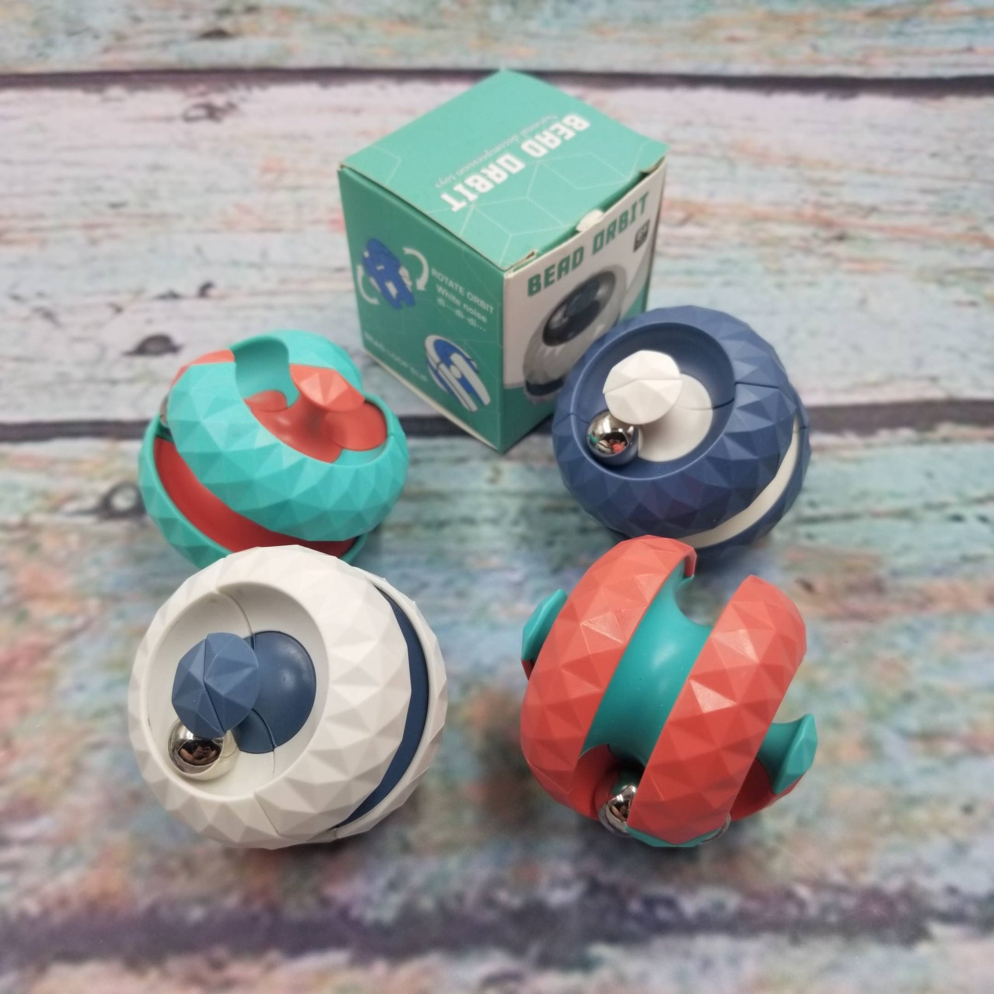 Colorful fidget toys with a box on a wooden surface