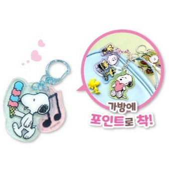 Snoopy keychain with ice cream and music notes on a white background