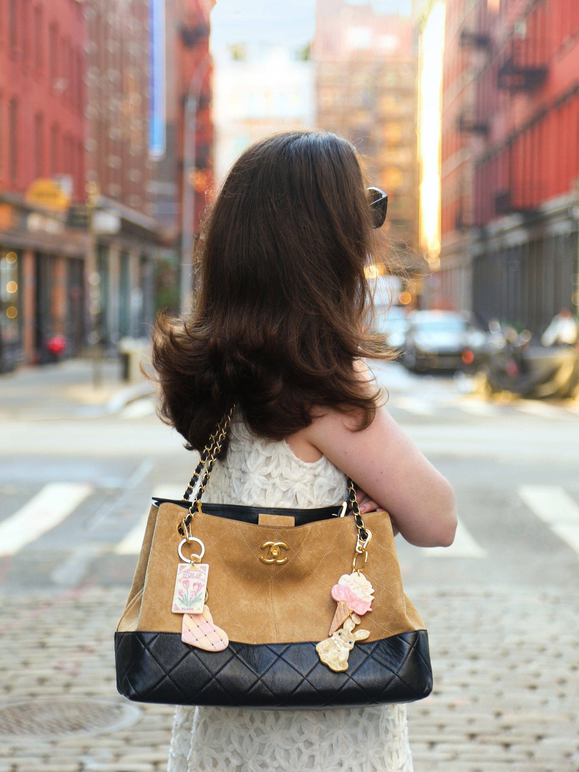 Woman holding a Chanel handbag on a city street