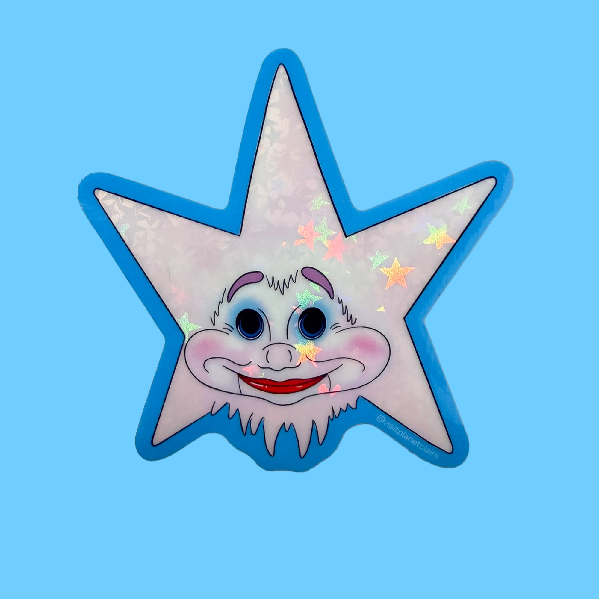 Star-shaped patch with a cartoon face on a blue background