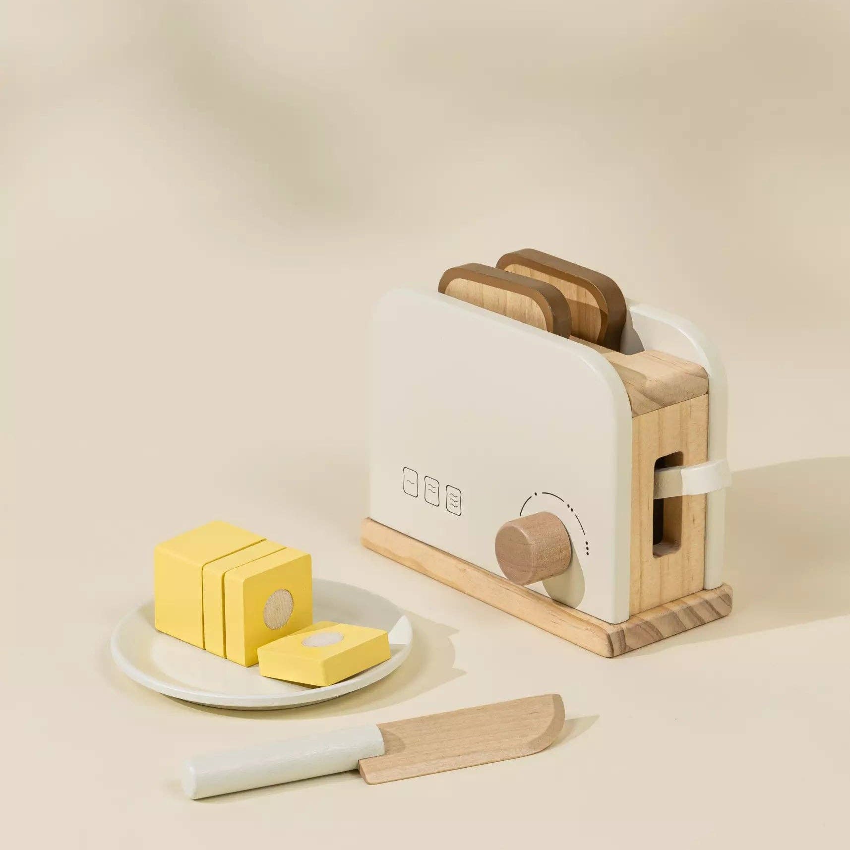 Wooden toaster with slices of bread and butter on a beige background