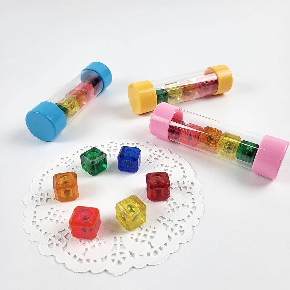 Colorful transparent tubes with small cubes on a white surface