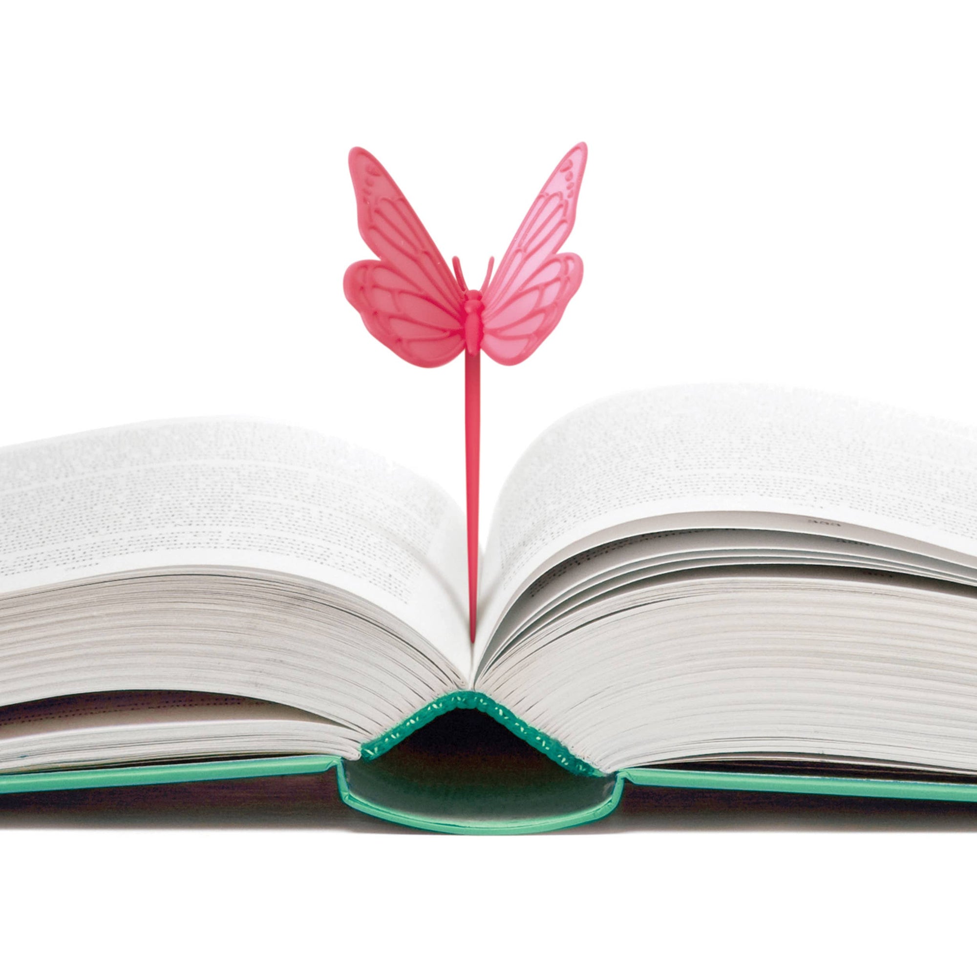 Pink butterfly-shaped bookmarker on an open book with a white background