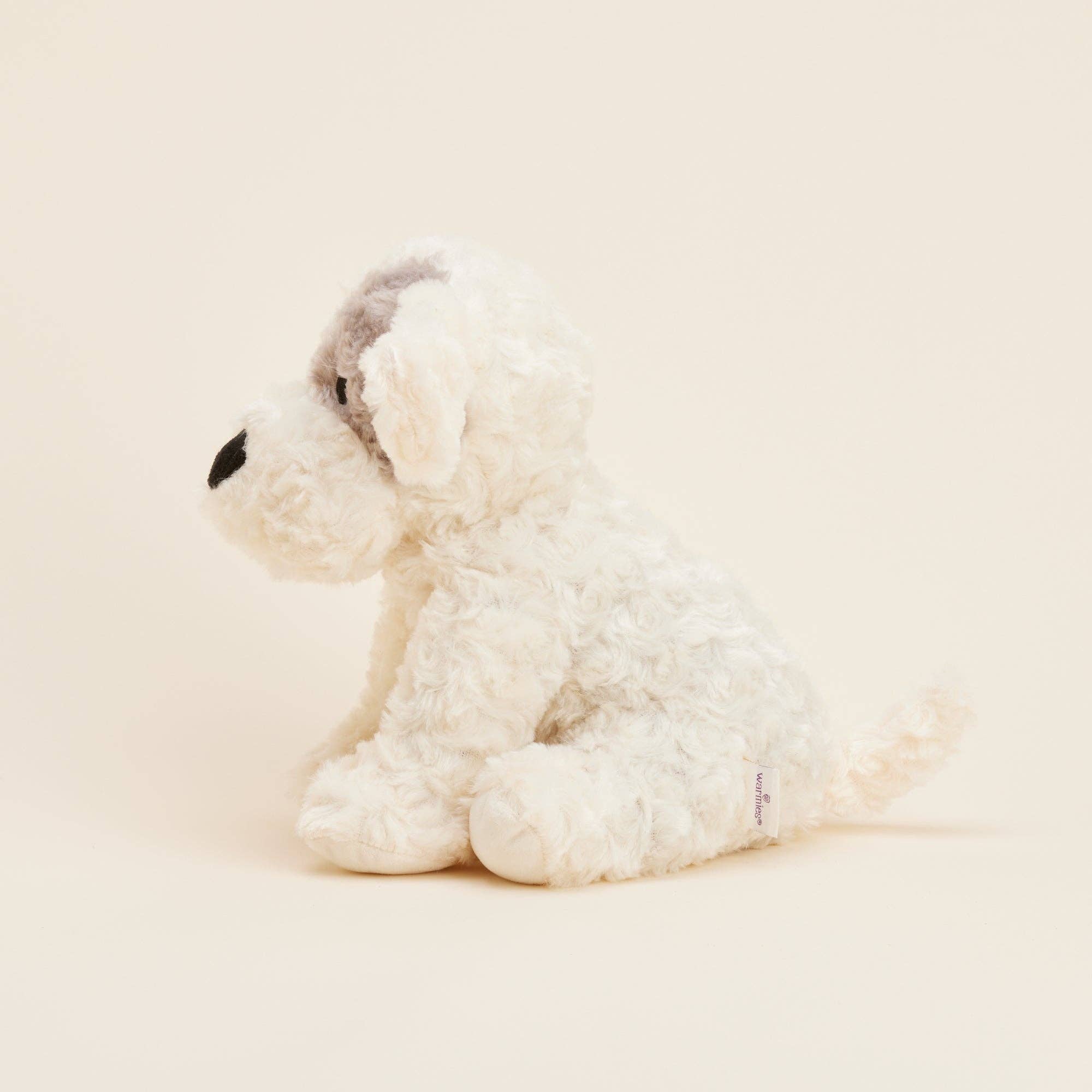 White plush dog toy on a beige background