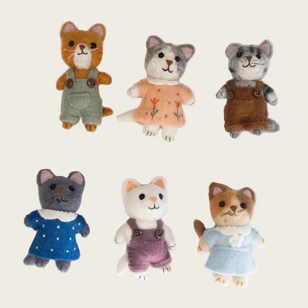 Set of six small animal plush toys with clothes on a white background