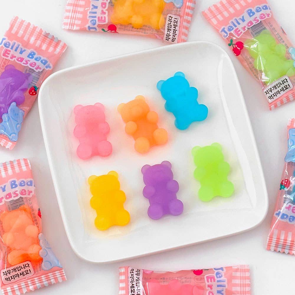 Colorful jelly bear erasers on a white plate with packaging in the background.