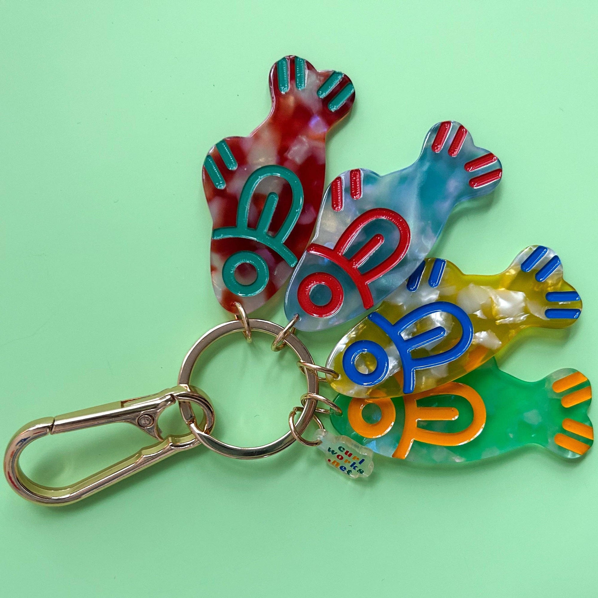 Colorful fish-shaped keychain on a green background