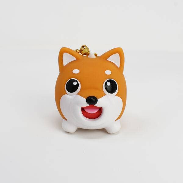 Cute dog-shaped keychain on a white background