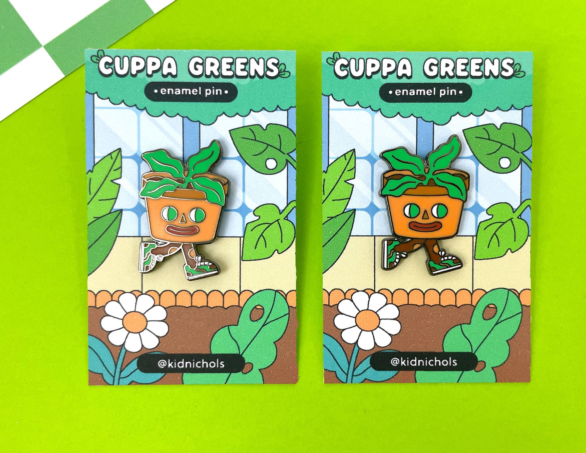 Two 'Cuppa Greens' enamel pins with a cartoon plant design on green packaging.