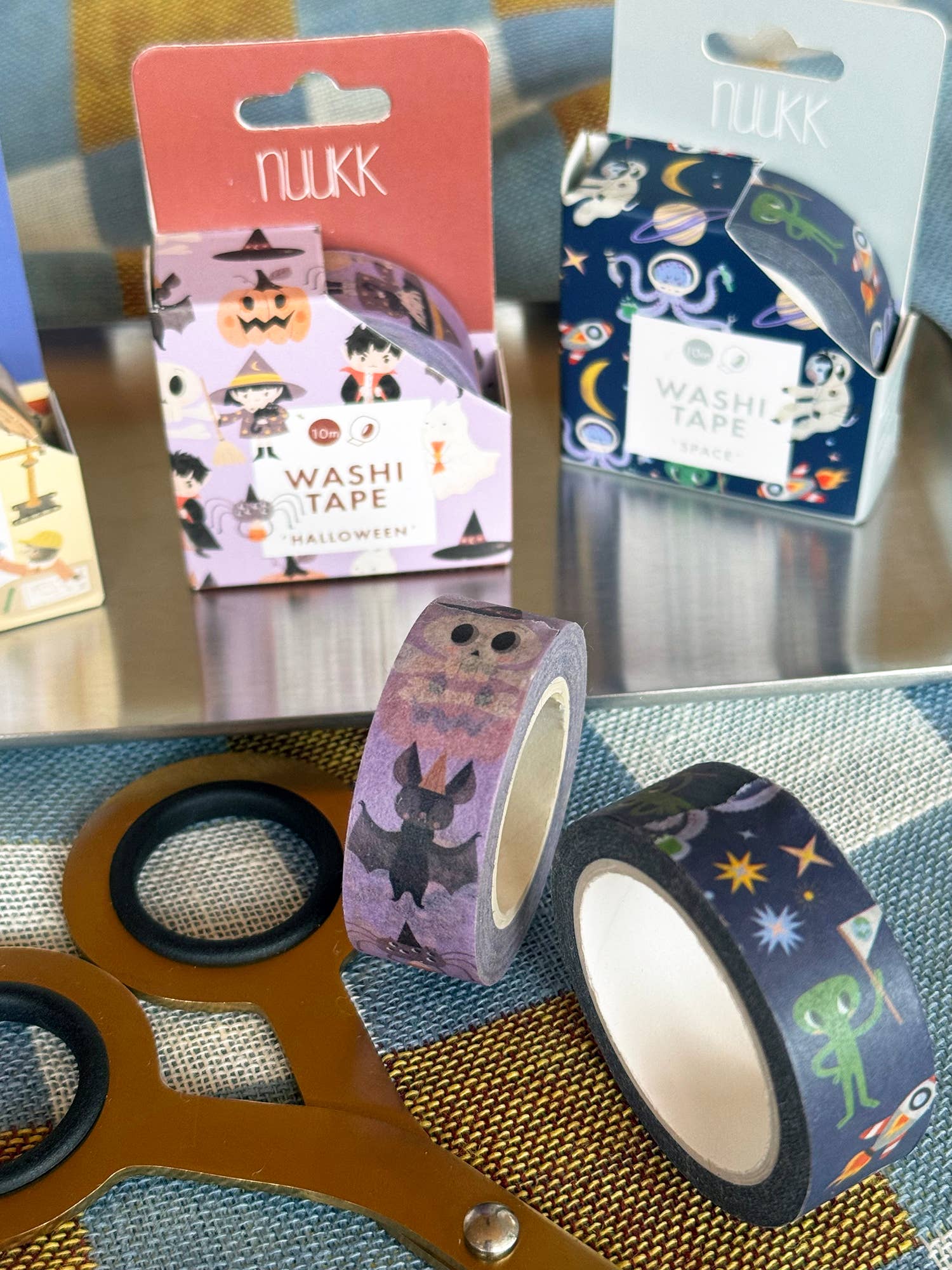 Washi tape with colorful designs on a table, featuring Nuukk brand packaging.