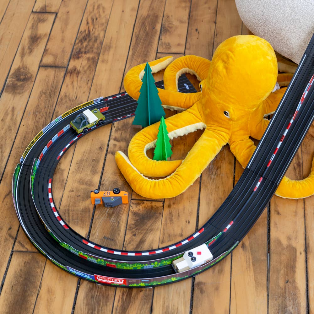 Toy track set with a yellow octopus toy on a wooden floor