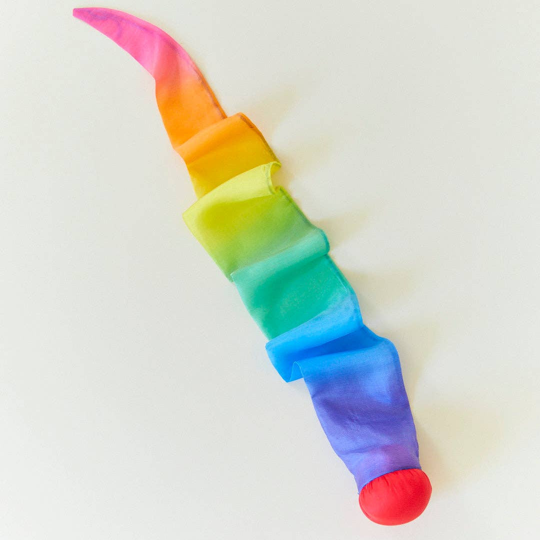 Colorful unicorn horn toy on a white background