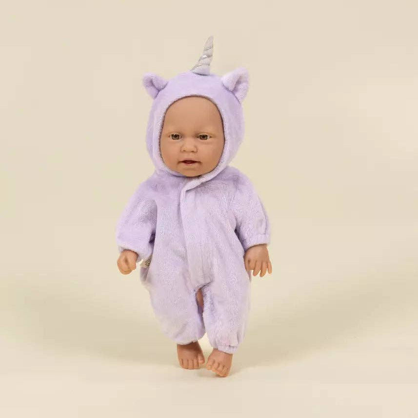 Doll wearing a purple unicorn onesie on a beige background