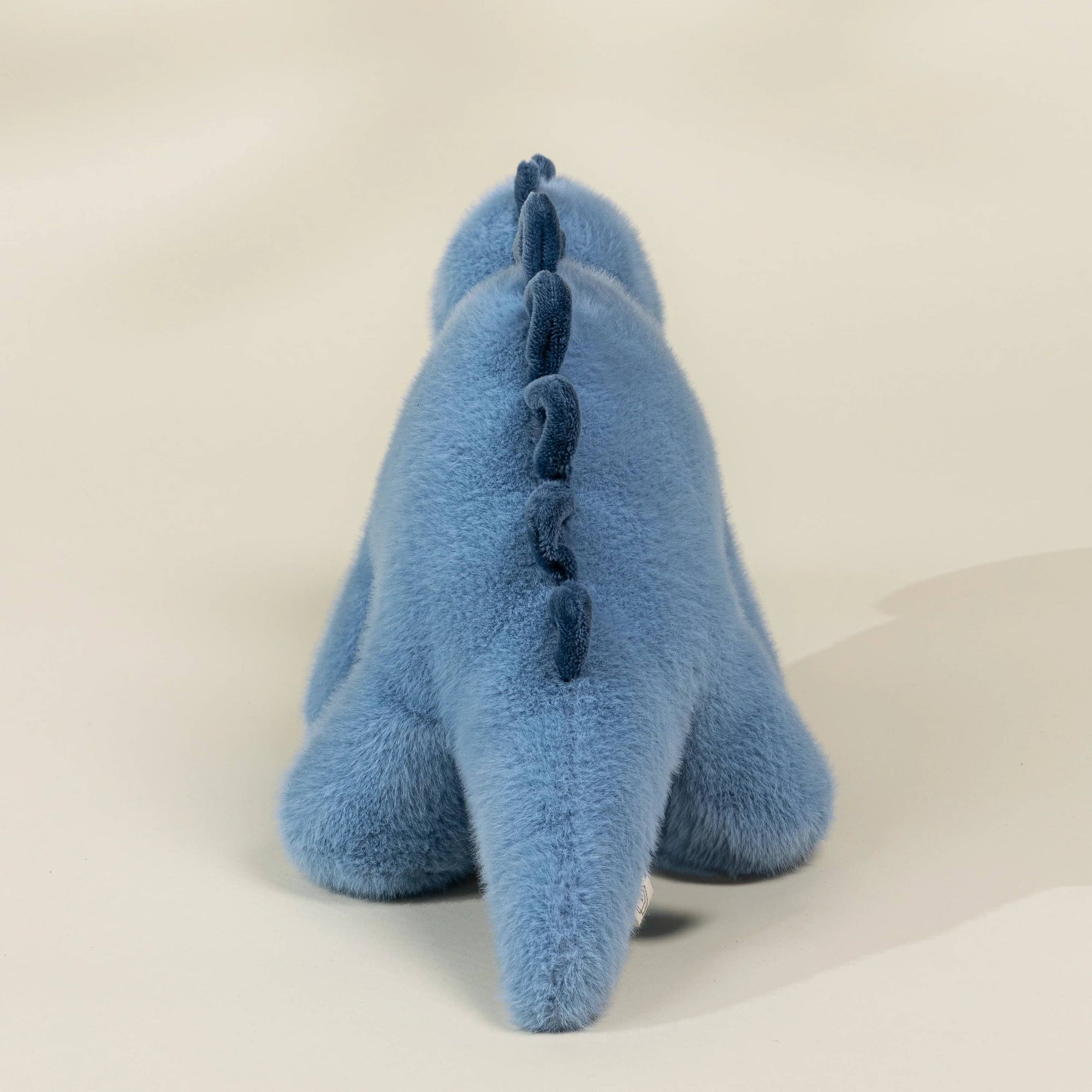 Blue plush toy on a beige background