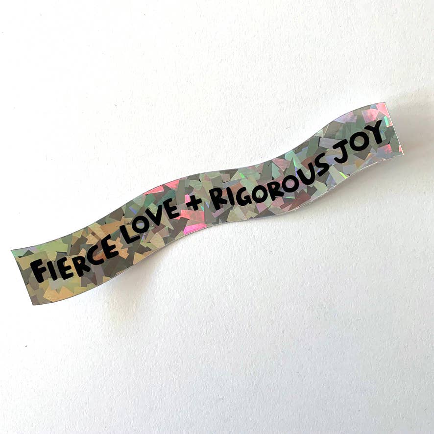 A wavy, metallic holographic sticker with the text 'FIERCE LOVE + RIGOROUS JOY' in black, displayed on a clean white background.