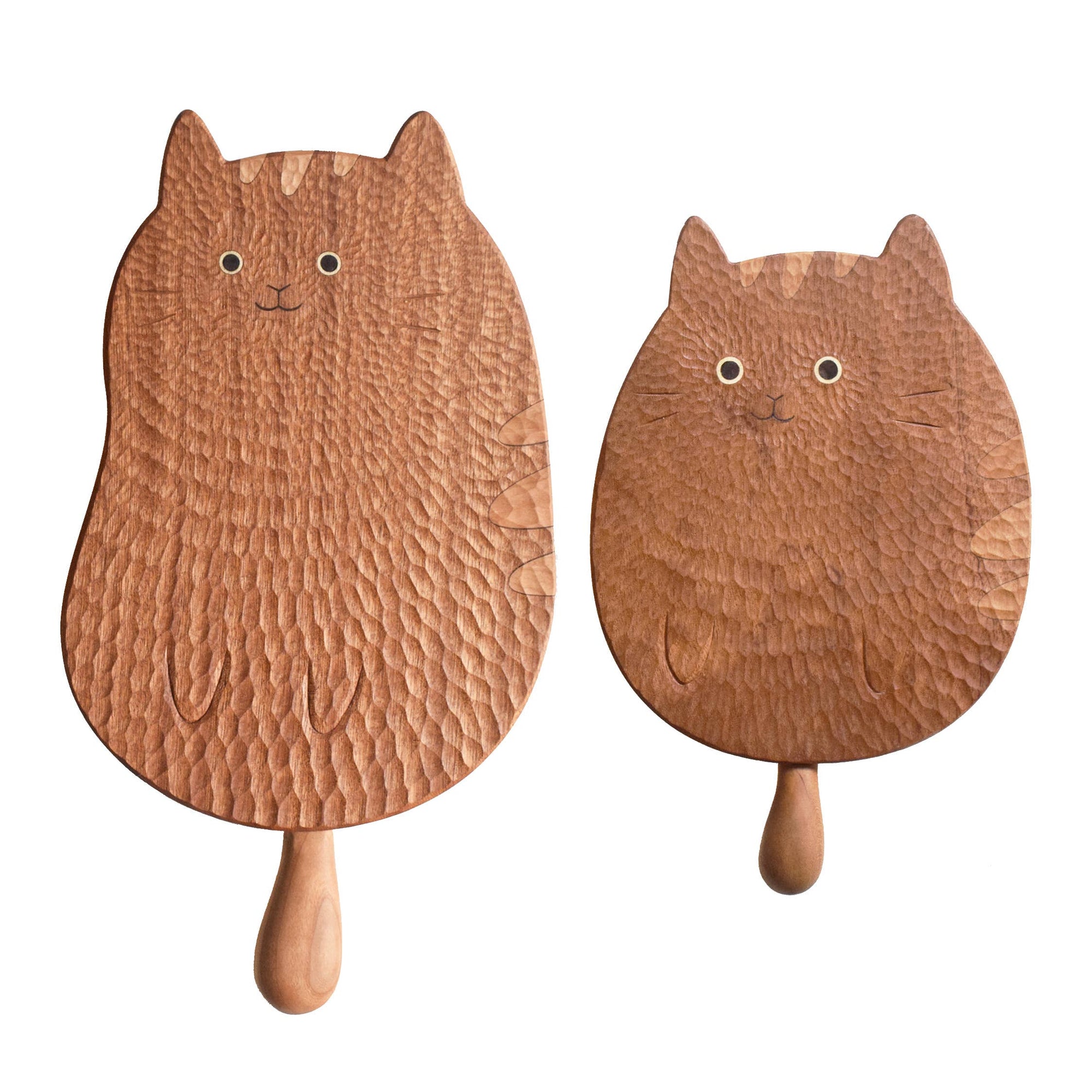 Two wooden paddle fans shaped like cats on a white background