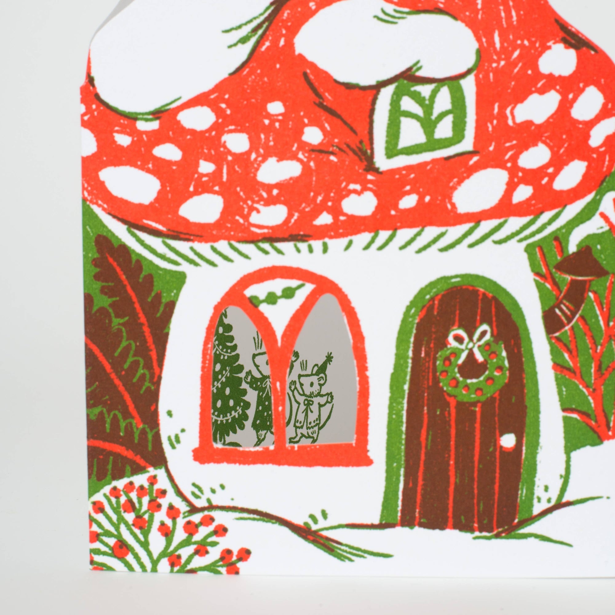 Illustration of a festive mushroom house with a door, window, and wreath on a white background.
