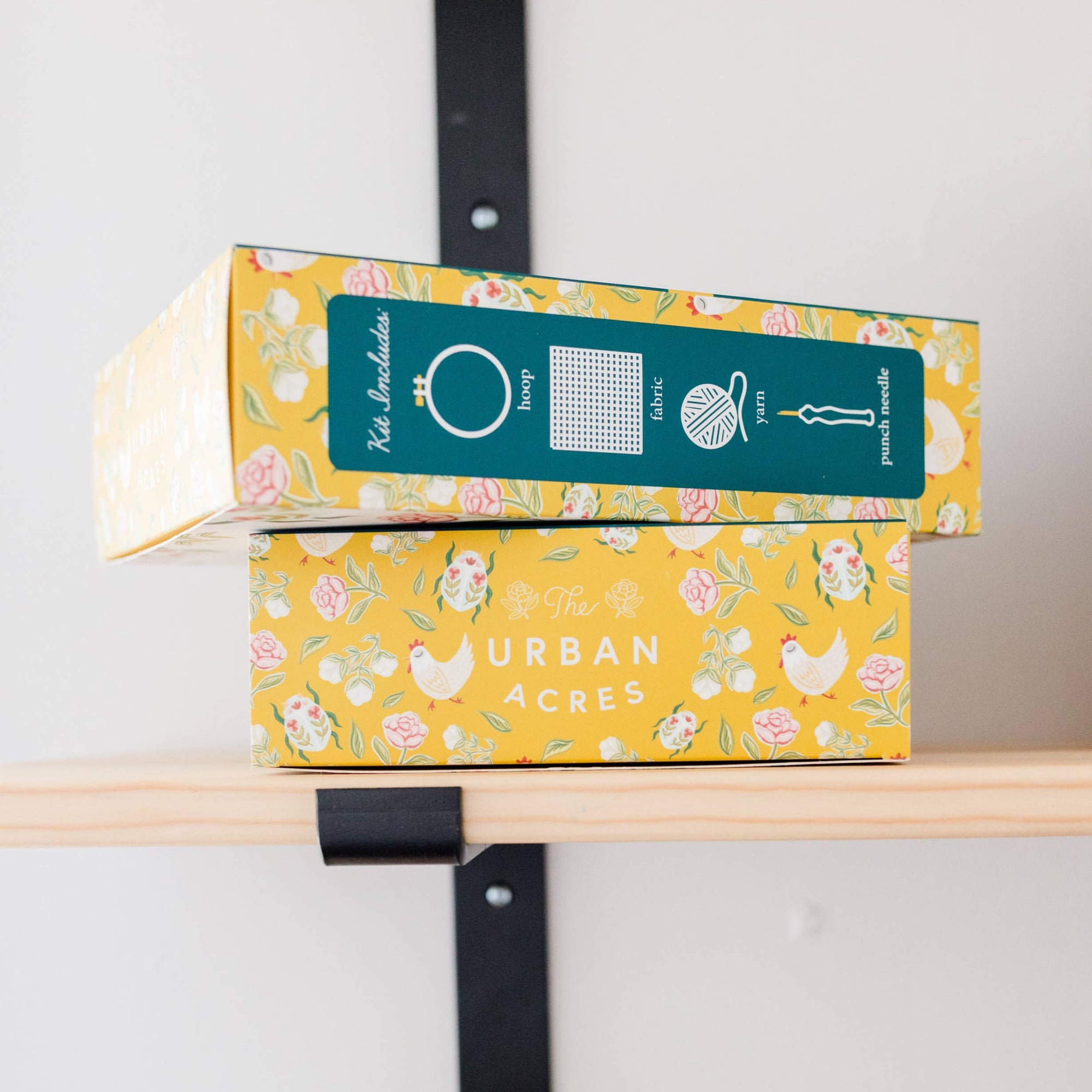 Colorful boxes with 'Urban Acres' branding on a shelf against a white wall.