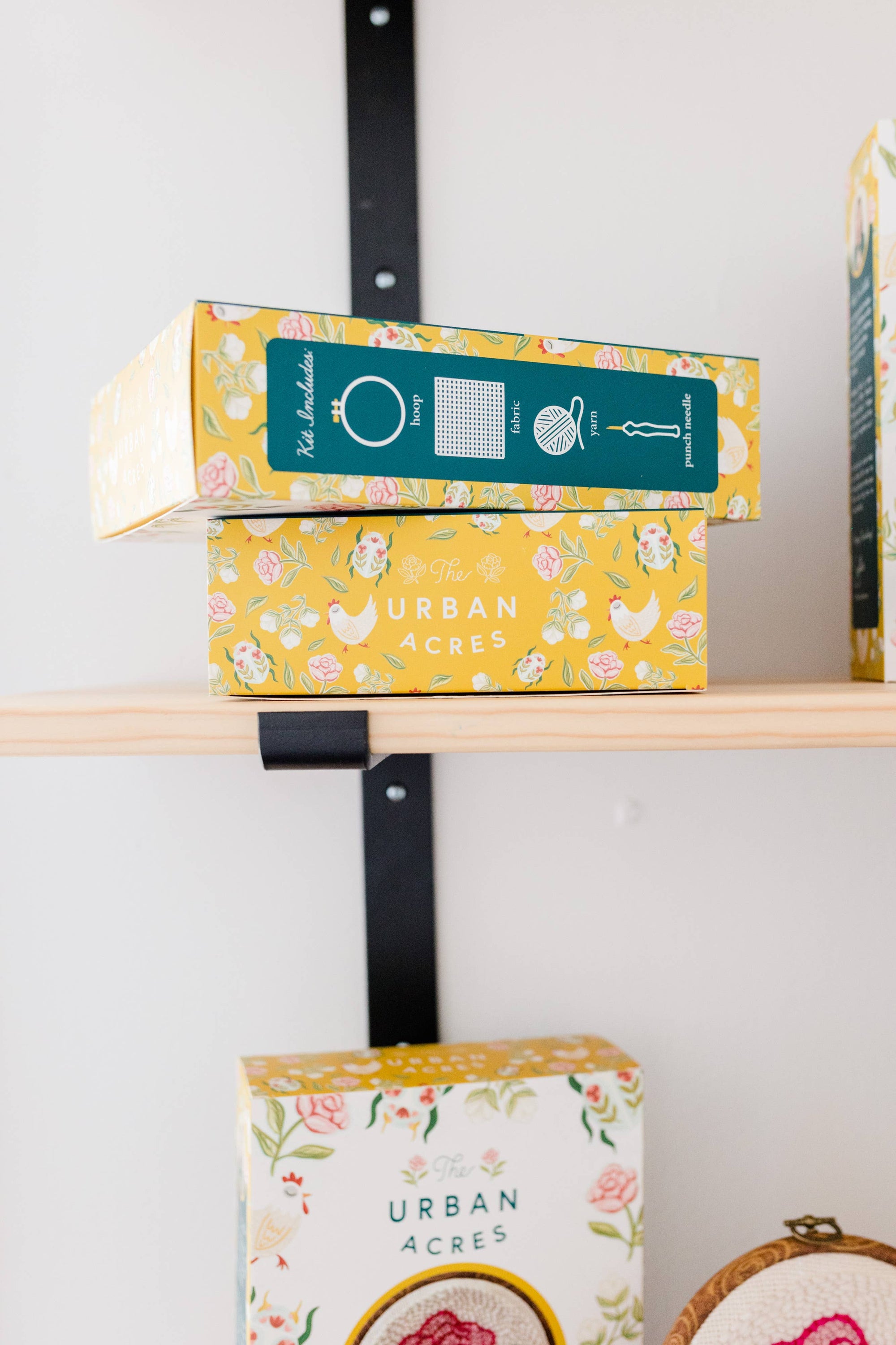 Colorful boxes with 'Urban Acres' branding on a shelf.