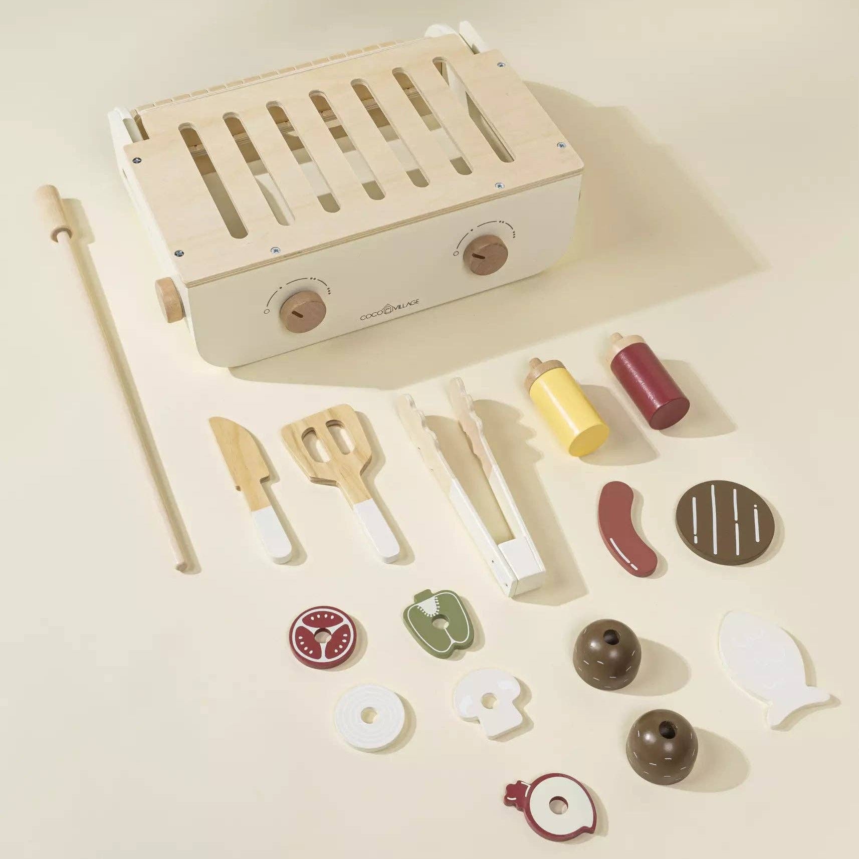 Wooden toy grill set with accessories on a beige background