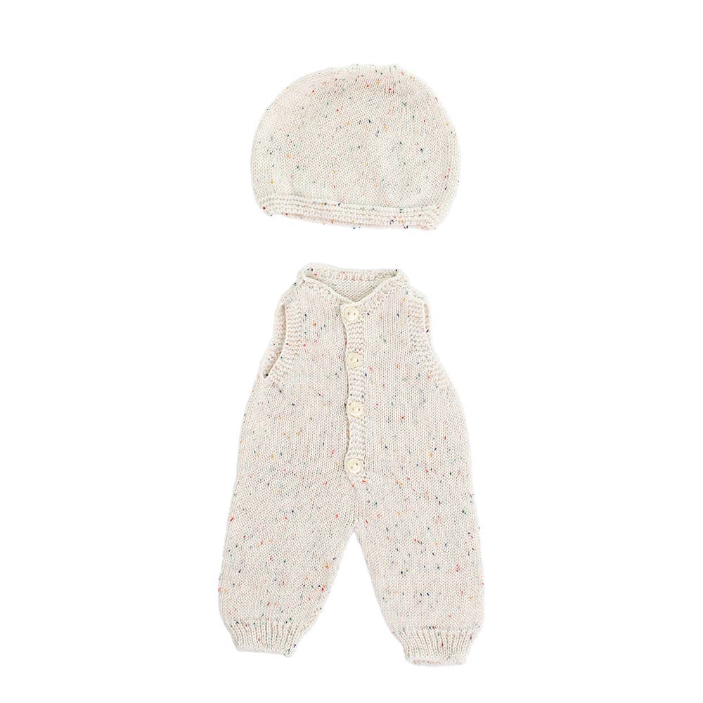 Knitted doll romper and hat set on a white background