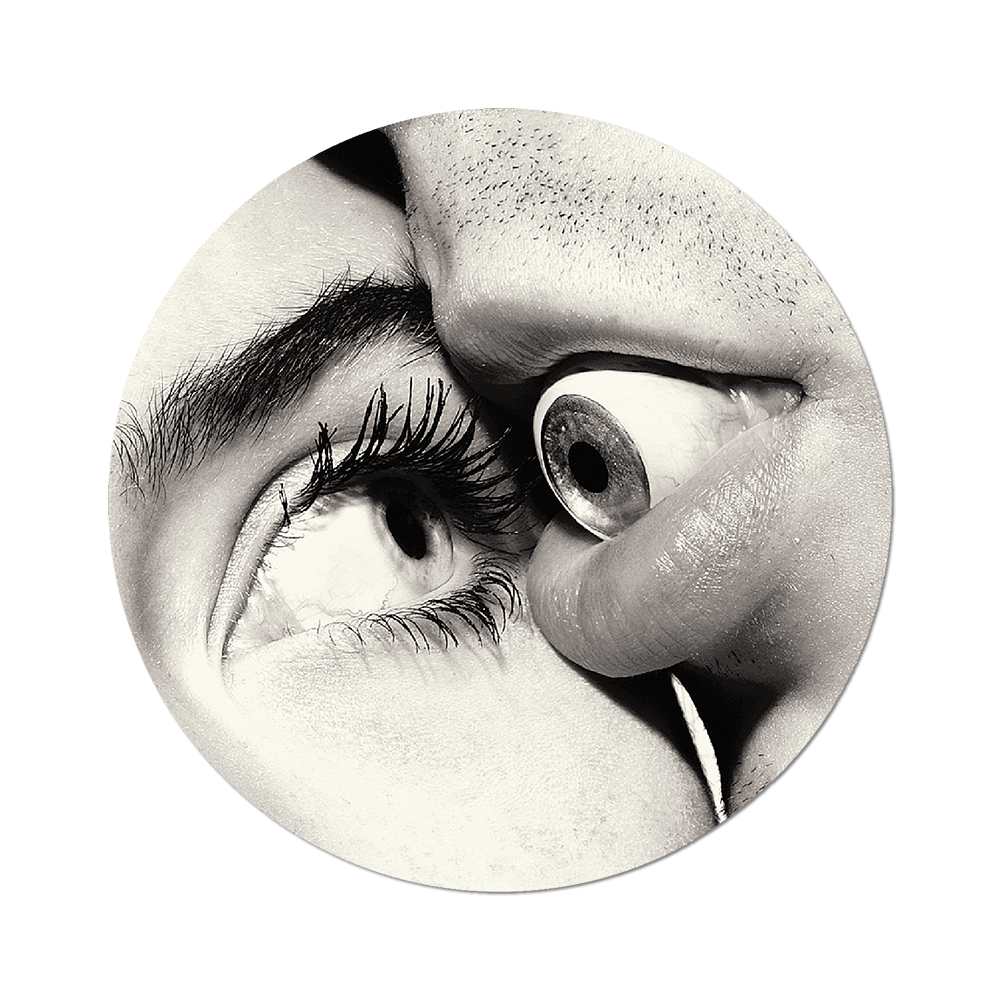 Close-up of a person's eye with an eye in between lips