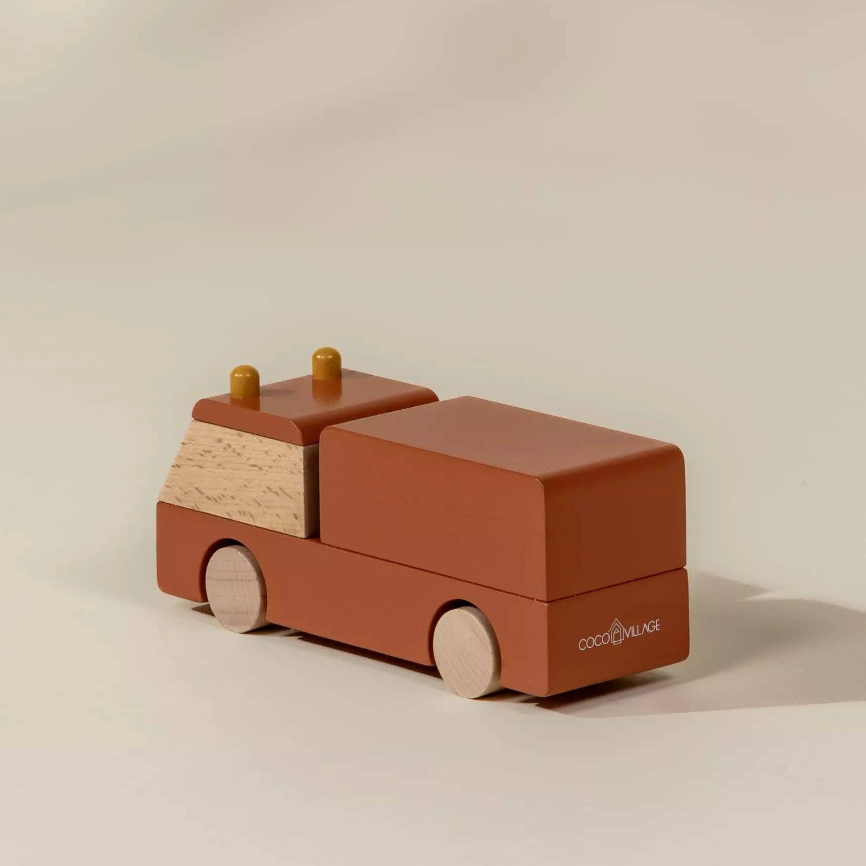 Wooden toy truck on a beige background