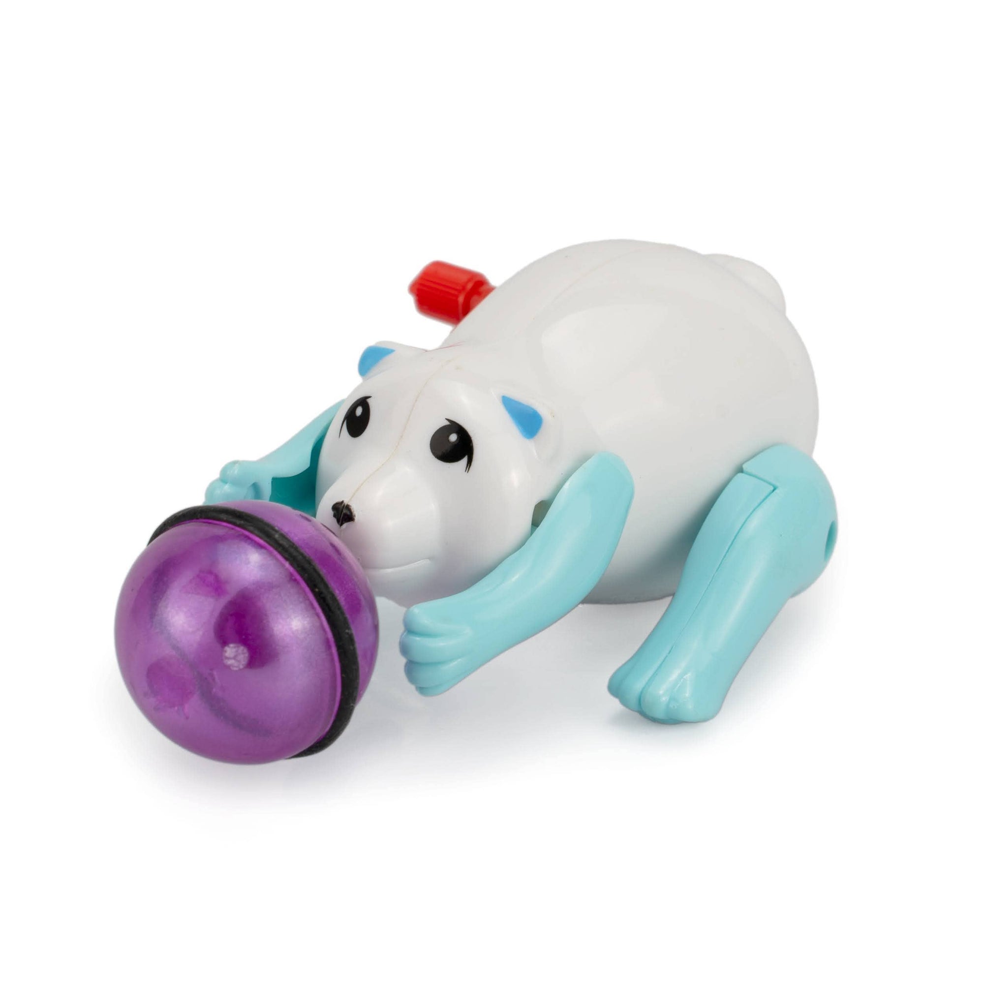 Toy figure of a white dog with a purple ball on a white background