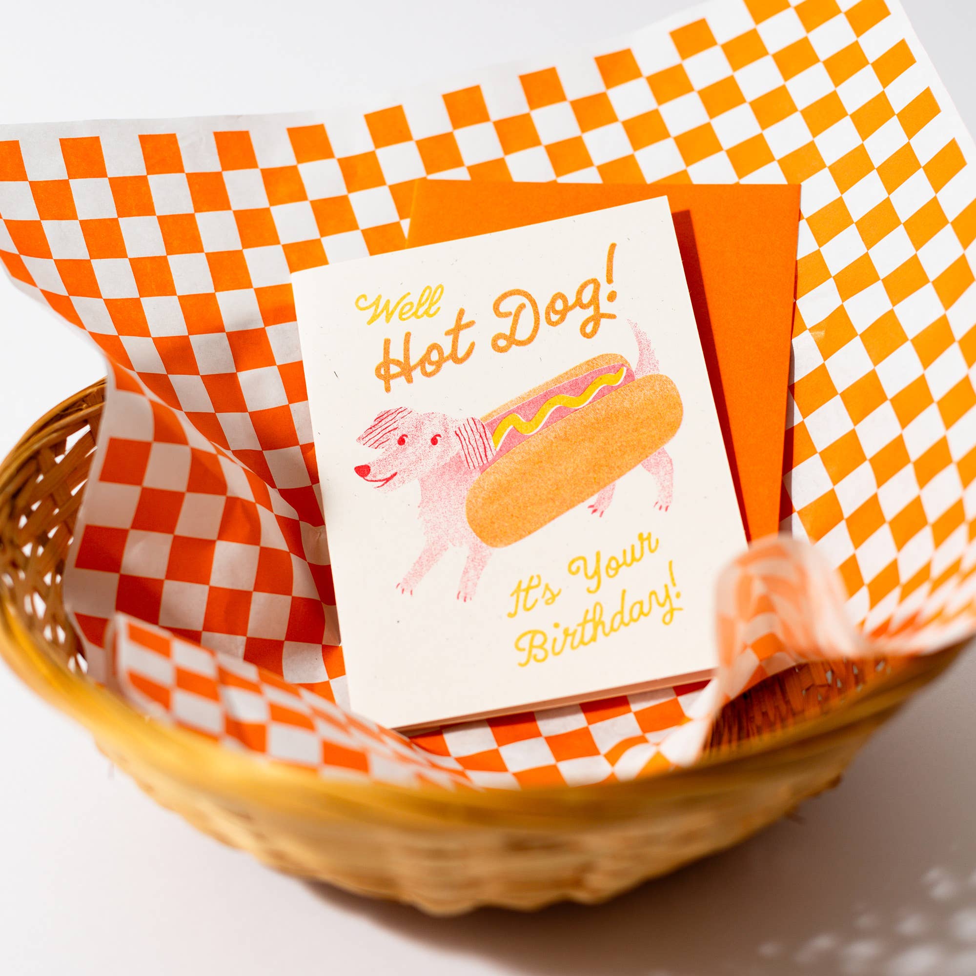 Birthday card with hot dog illustration in a basket lined with checkered paper