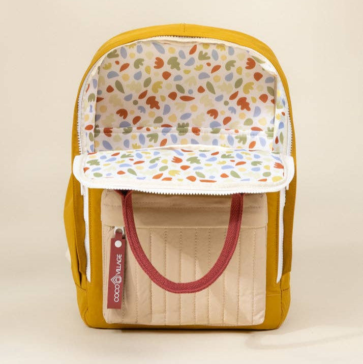 Backpack with colorful interior lining on a beige background