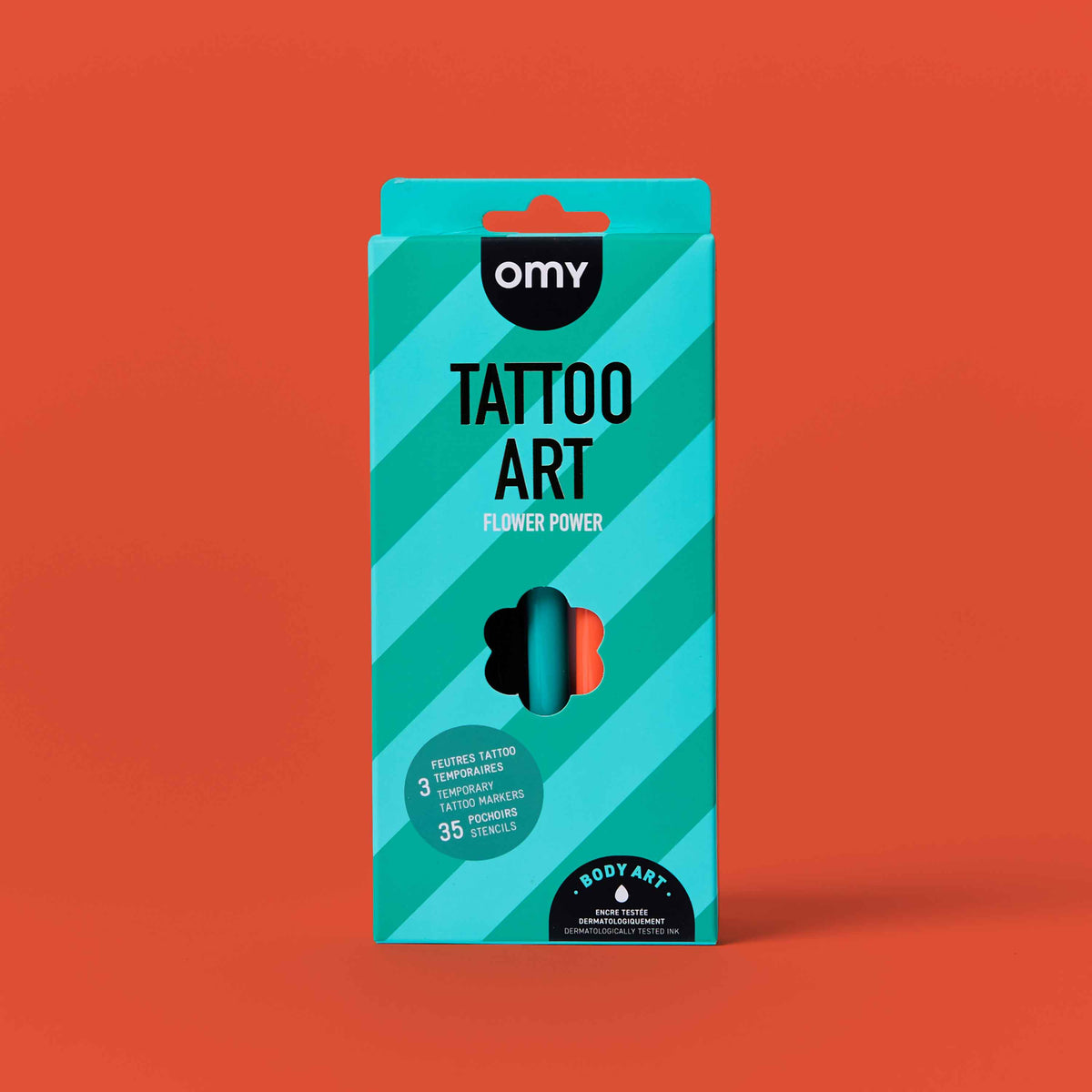 Packaging of OMY Tattoo Art with a blue design on an orange background