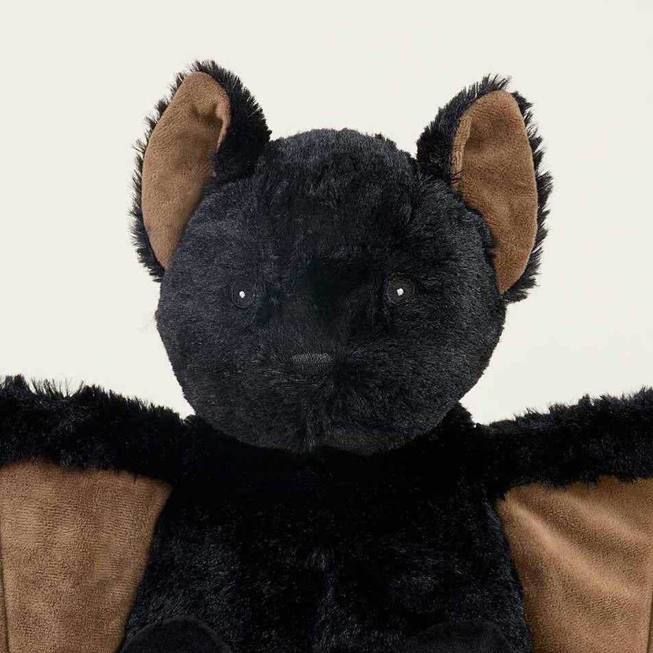 Black plush toy with brown accents on a white background