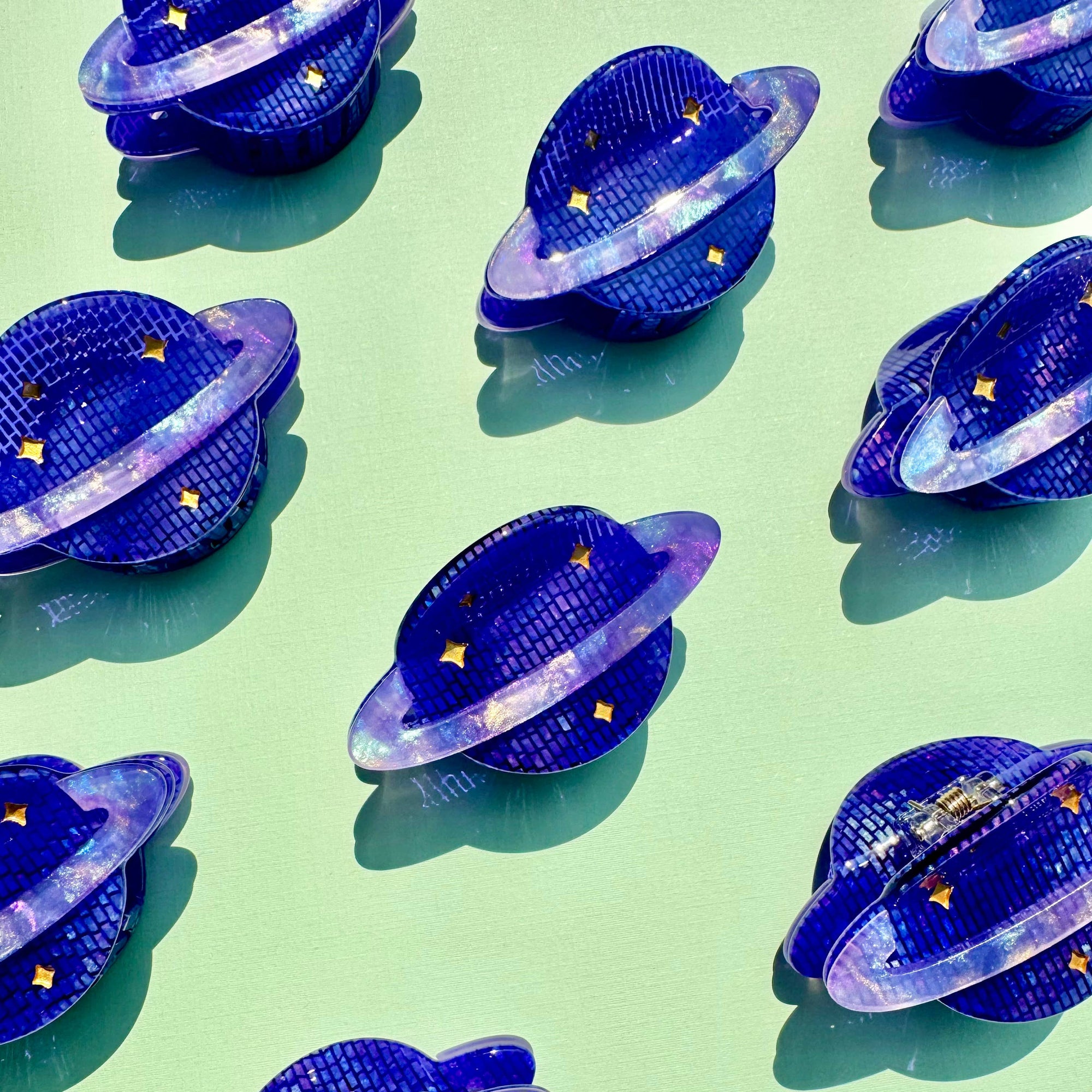 Pattern of blue UFO-shaped objects on a green background