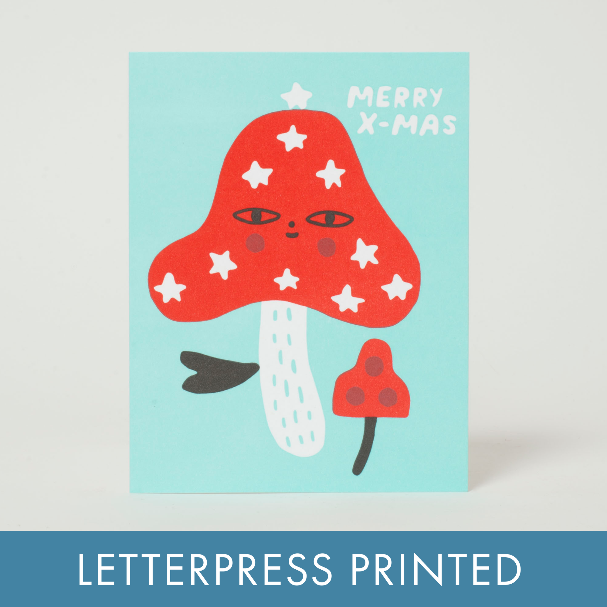 Merry Christmas card with a red mushroom illustration on a light blue background, featuring the text 'Merry X-Mas'.