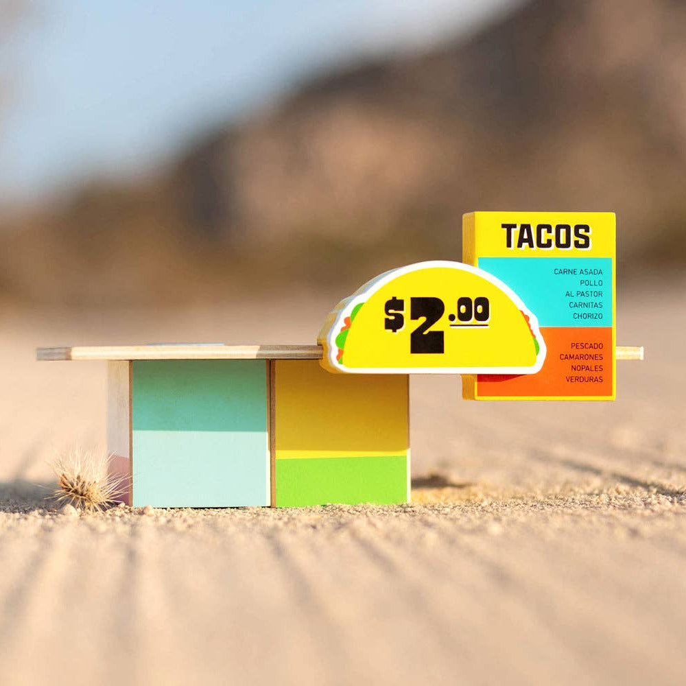 Colorful taco stand with price sign on a desert background