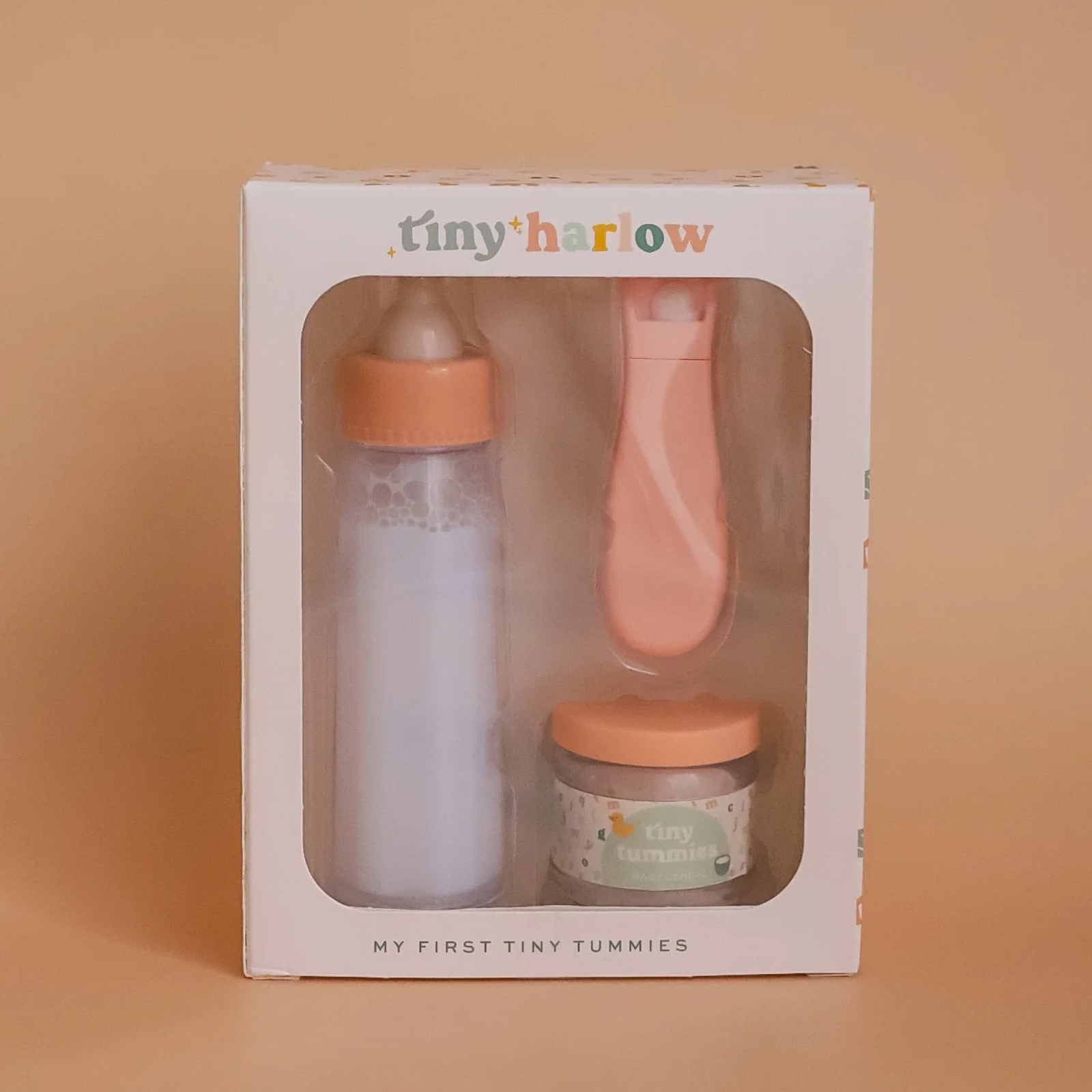 Baby product set in a Tiny Harlow packaging on a beige background