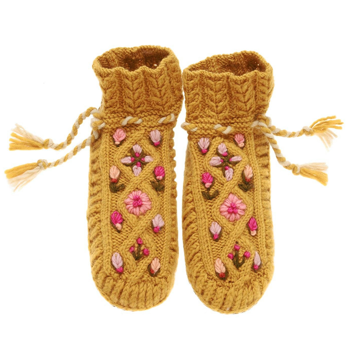 Pair of mustard yellow knitted baby booties with floral patterns on a white background