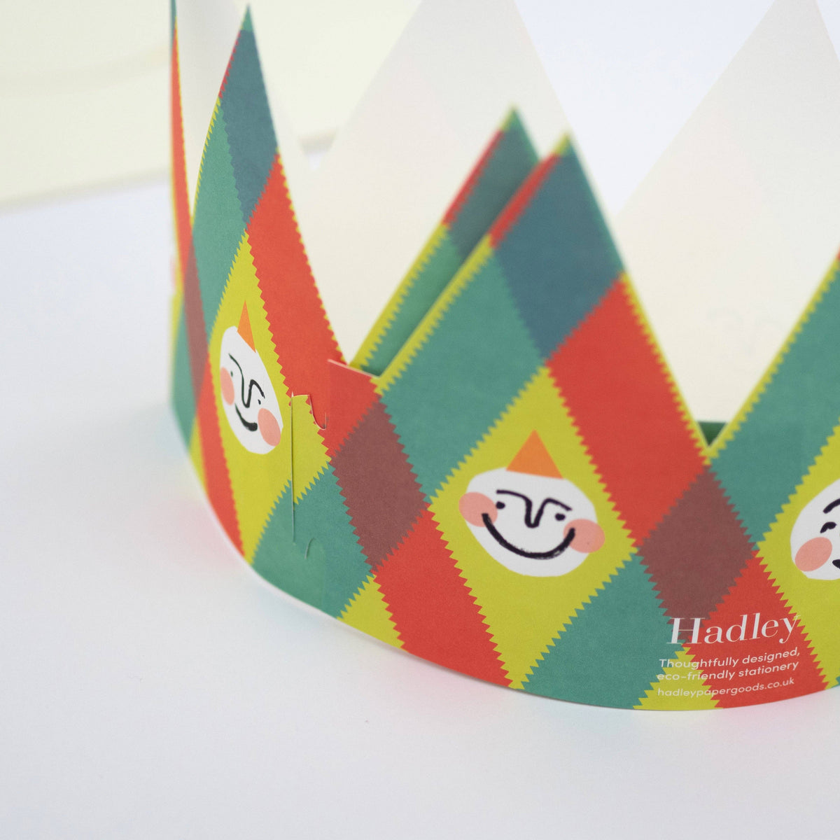 Colorful patterned headband with smiley face designs on a white background