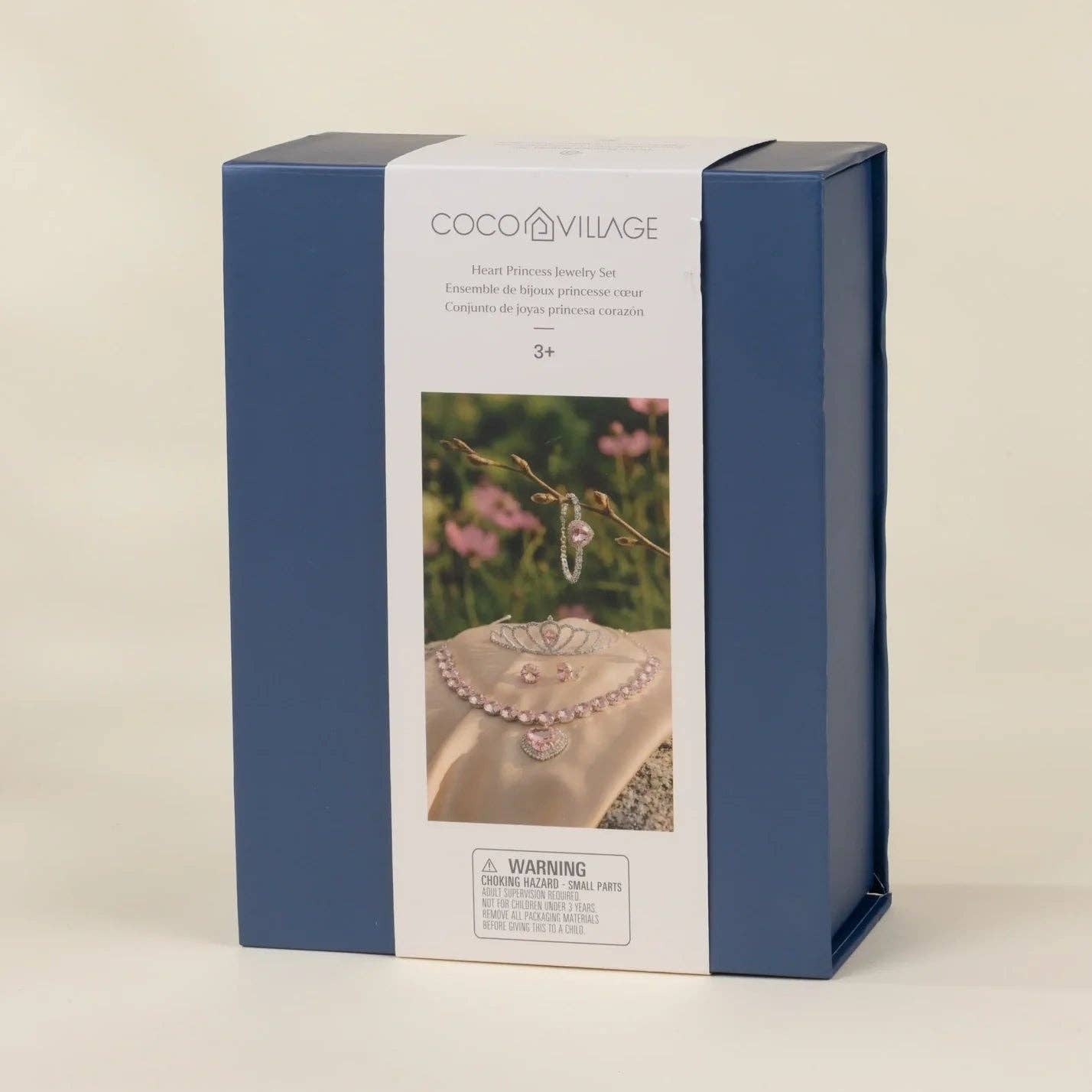 A rectangular product box for Coco Village hair jewelry, featuring a navy blue side design and a white front label with a photo of a pearl hairpiece and a ring, set against a plain beige background.