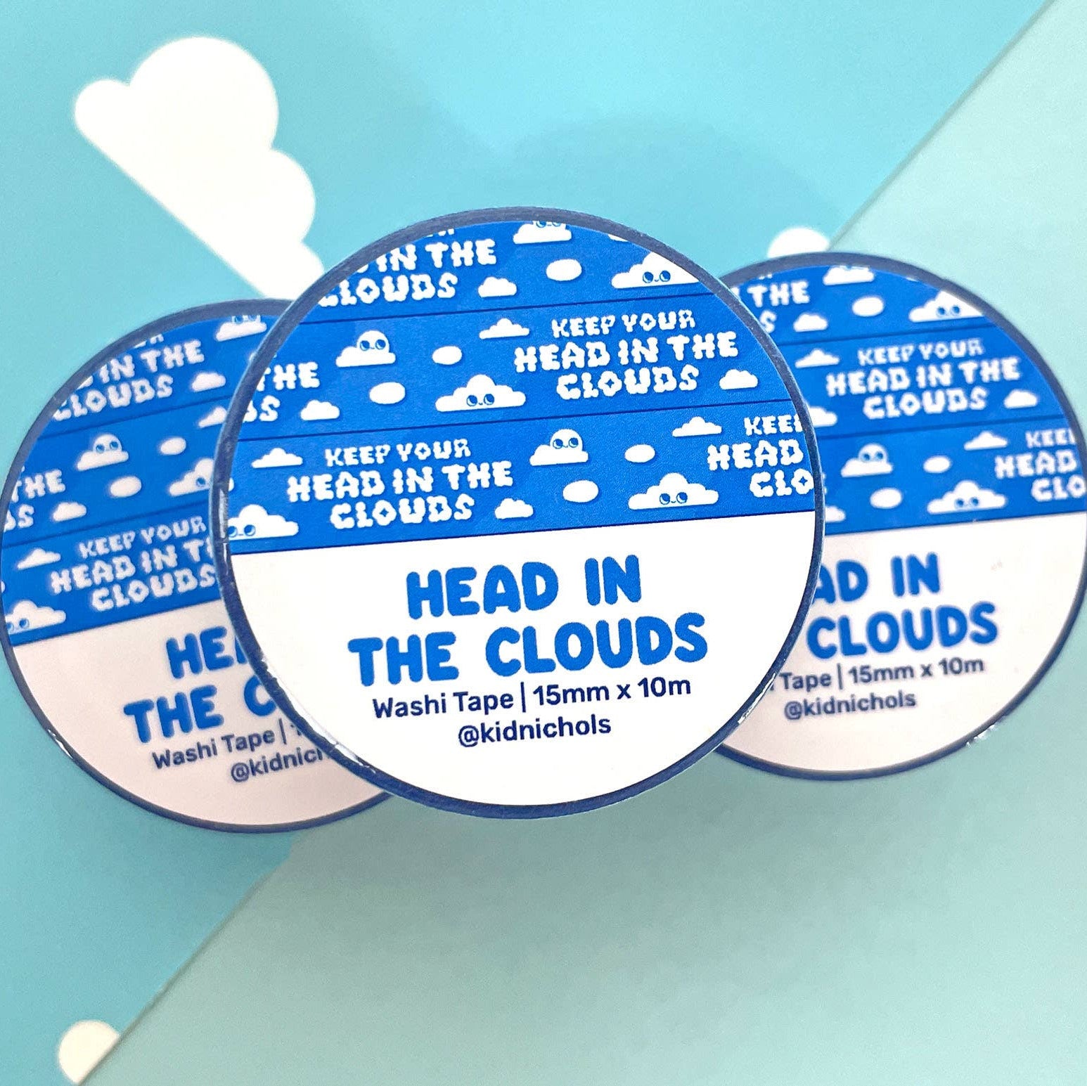 Three circular washi tapes with 'Head in the Clouds' text on a light blue background